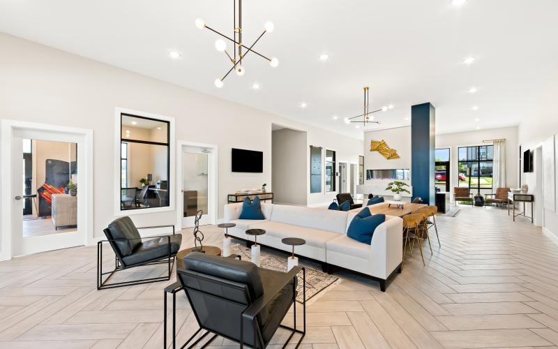 a living room with a large white couch and a large glass door