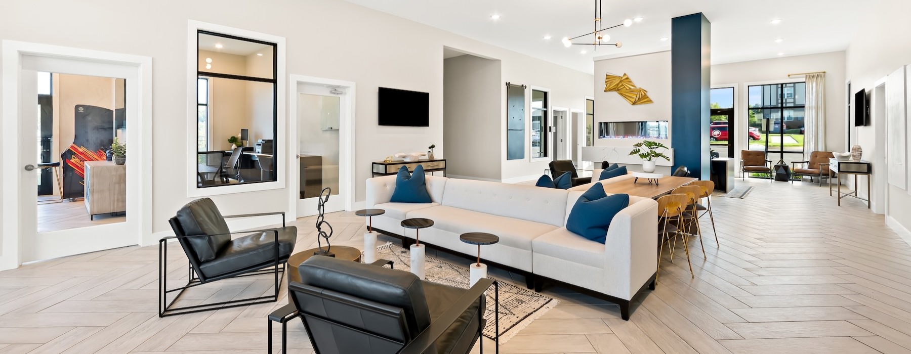 a living room with a large white couch and a large glass door