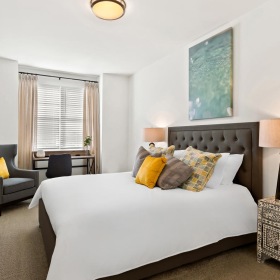 a bedroom with a bed and a table