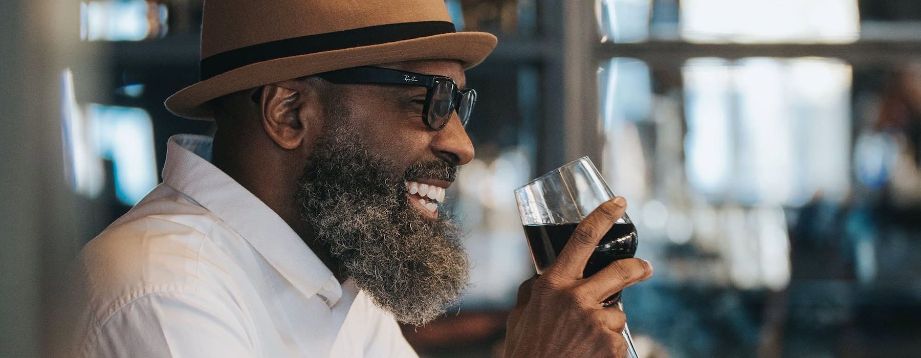 man sitting with a glass of wine in his hand